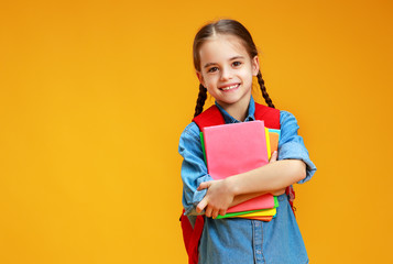 funny child school girl girl on yellow background    .