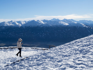 Naklejka na ściany i meble Turista caminando por el paisaje nevado de las montañas del Nordkette en Innsbruck Austria, invierno de 2018