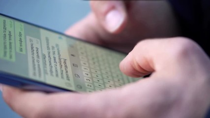 Close-up View of Man Using Smartphone in the city street
