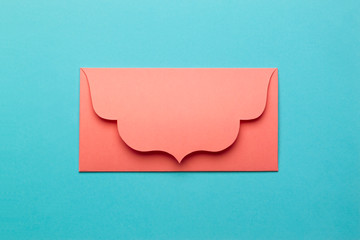 The orange envelope on turquoise paper background.