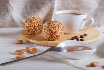 Energy balls cakes with nuts  on wooden board on linen napkin.