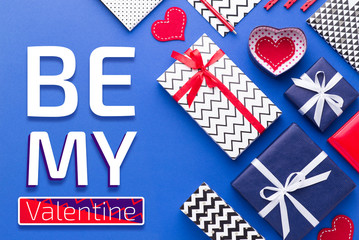 Person holding a present for Saint Valentine's day in his hands. Beautiful colorful background to st. Valentine day. Greeting card with red hearts. Wedding's invitation. Love expression. 