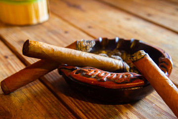 Cuban cigars on an ashtray  at a tobacco farm in Vinales town, in the north-central Pinar del Río Province of Cuba