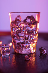 Glass of pure water with ice cubes.Abstract dynamic backdrop for your design