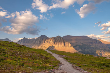 Trail leading to mountains at sunset - Glacier national park