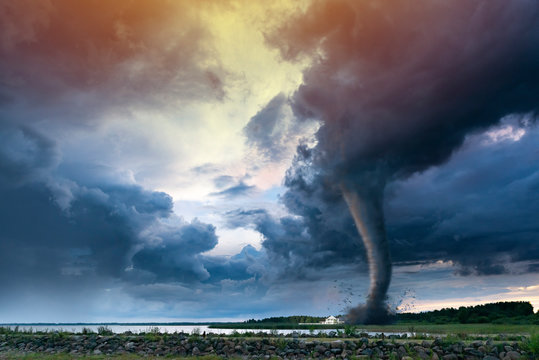 Tornado forming destruction over a populated landscape with a house on it's way. 