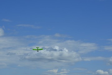 Sports plane in the sky performs aerobatics