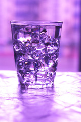Glass of pure water with ice cubes.Abstract dynamic backdrop for your design