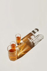 Fototapeta premium Glasses with drink. Colored shadows.