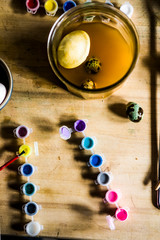 Dyeing eggs for Easter holidays, coloring with different color and tonality using natural food dye...
