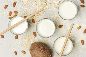 Assortment of organic vegan non-dairy plant-based milk in glasses, top view