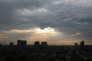 Fototapeta premium Silhouette City downtown with sunset and clouds background in the evening.