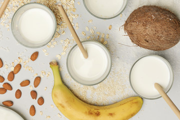 Assortment of organic vegan non-dairy plant-based milk in glasses, top view