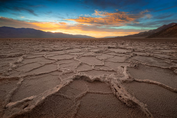 Death Valley National Park Badwater area at sunset. The salt flatsof this area creates a rare...
