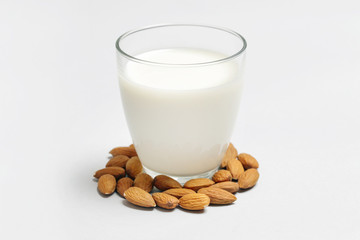 Almond milk and nuts. Organic vegan non-dairy plant-based milk in a glass.