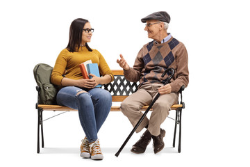 Young female student talking to an elderly man on a bench