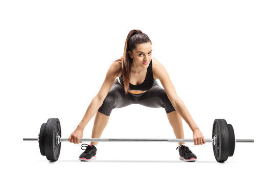 Young Female Athlete Kneeling And Lifting Weigths