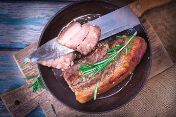 Fried juicy barbecue meat baked in the oven on a baking sheet with french mustard