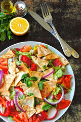 Bright juicy Fattush salad. Lebanese fresh salad with pita. Middle Eastern cuisine. Arabian salads.