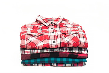 Set of colored checked shirts on a white background