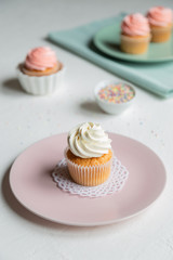 Cupcakes decorated with pastel pink plate and pastel green towel