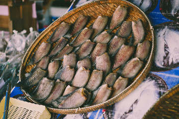Many dried salted damsel fish on basket in market