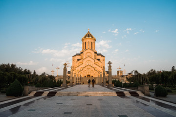 cathedral in Tbilisi, Georgia, covered in orange sun lit during sunset