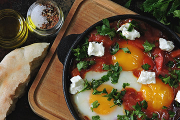 Shakshuka in a cast iron skillet. Middle Eastern cuisine.