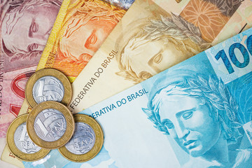 Brazilian money and coins on a table. Economy concept image.