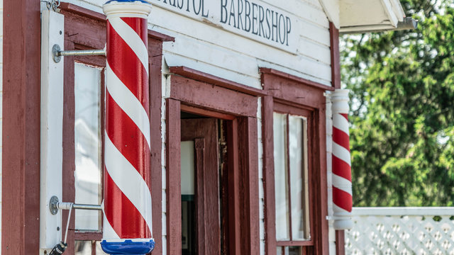 An historic barber shop put on display in an historic town in North East Ohio. A barber's pole is a type of sign used by barbers to signify the place or shop where they perform their craft.