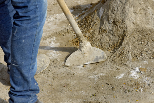 Mason Prepares Mortar With Hoe