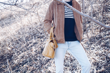 A man carrying a woman's purse