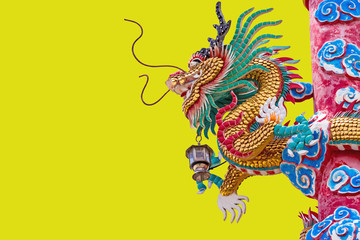 Chinese style dragon statue on yellow background.