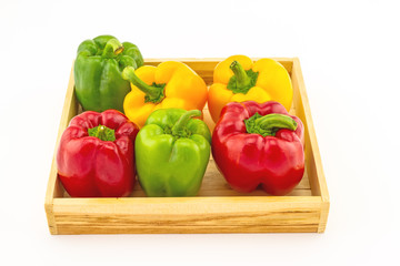 Colorful of fresh  sweet bell pepper (capsicum)   in wooden basket  product package on white  background