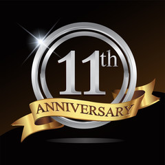 11th anniversary logo, with shiny silver ring and gold ribbon isolated on black background. vector design for birthday celebration.