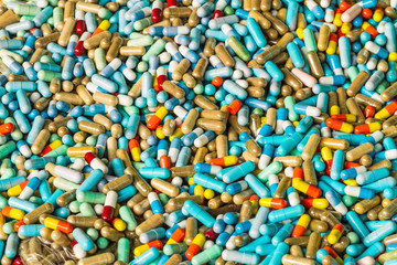 Many colorful medicines expire on cement floor