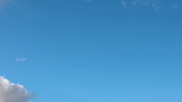 Cloudscape Time Lapse 01 Loop - Looping 60 second video footage features real clouds flying by in smooth time lapse fashion over a deep blue sky with no birds or airplanes spoiling the experience.