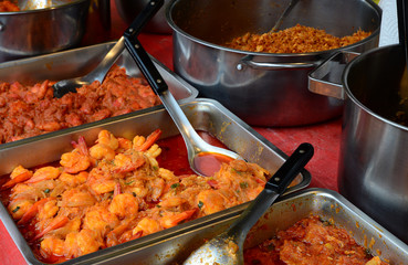 Spicy fried shrimp in traditional street market. India curry cuisine.