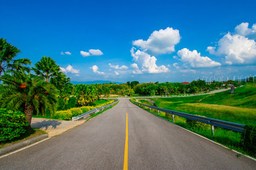 street view with green mountain on blue sky background in the province of Thailand. decoration image contain certain grain noise and soft focus.