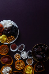 Eid Mubarak. Different iftar sweets. Celebrating Eid Al Adha. Islamic traditional holiday. Eid al-Fitr. Holly month Ramadan. Middle Eastern religious holiday. Dried date fruit. Flat lay, top view.