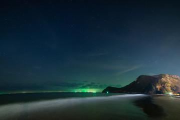 beach and mountains at night sky