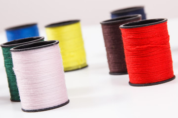 Spools of colorful thread as accessories for using in sewing.