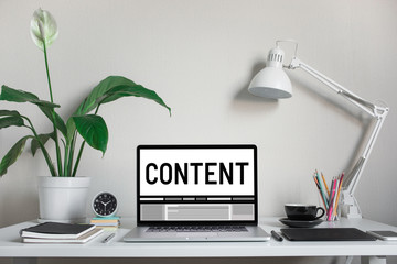Content marketing concepts with text on computer laptop and accessories on worktable