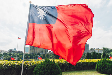 Taiwan national flag waving in the wind near the area of National Dr. Sun Yat-Sen Memorial Hall in Taipei, Taiwan.