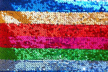 Obraz premium Sequins background.sequins striped fabric.Texture scales with Sequins close-up.Sequins multicolored stripe.Shiny texture sequin material