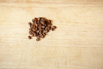 Raw coffee seed on wooden plate