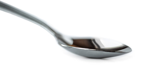 Spoon isolated on white background. Silver spoon Macro. Side view