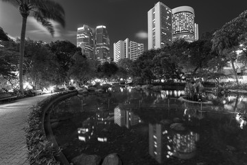 High rise office building and public park in midtown of Hong Kong city at night