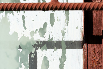 Old painted window behind iron bar close up. Grunge background