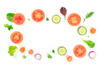 Fresh vegetable salad ingredients, shot from above on a white background. A flat lay composition with tomato, cucumber, onion slices and mezclun leaves, forming a frame with a place for text